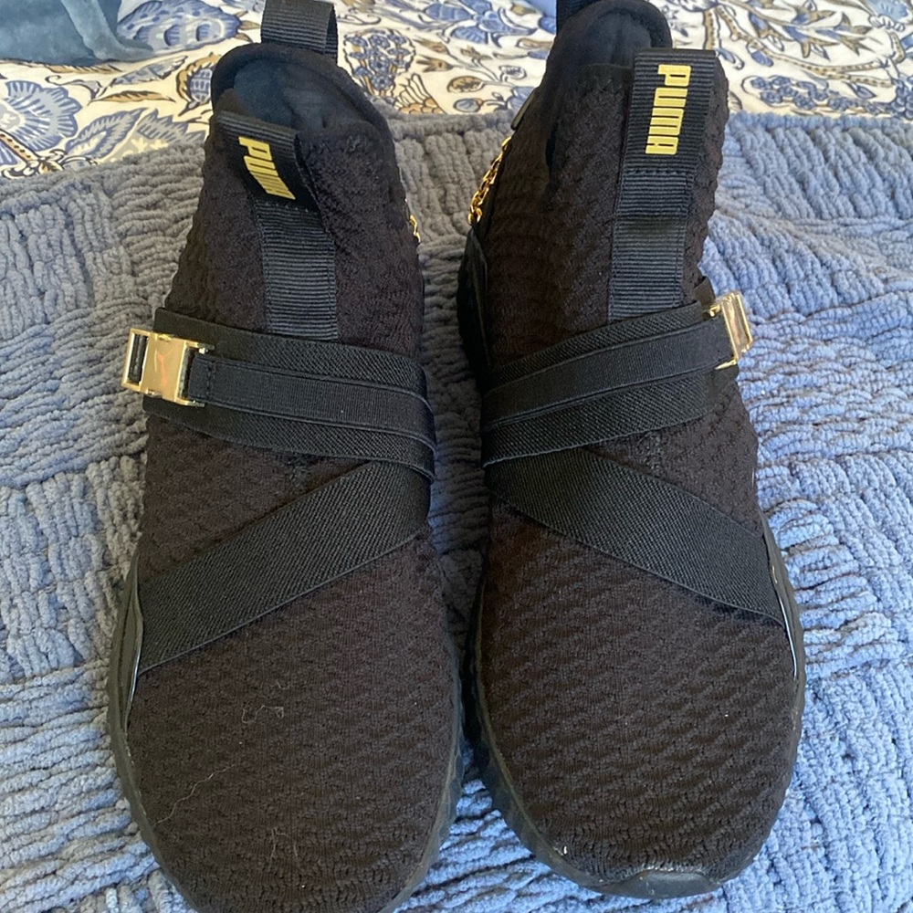 Black Puma gym shoes with gold accessories barely worn size 8 woman